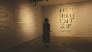 A person standing in a dimly lit room