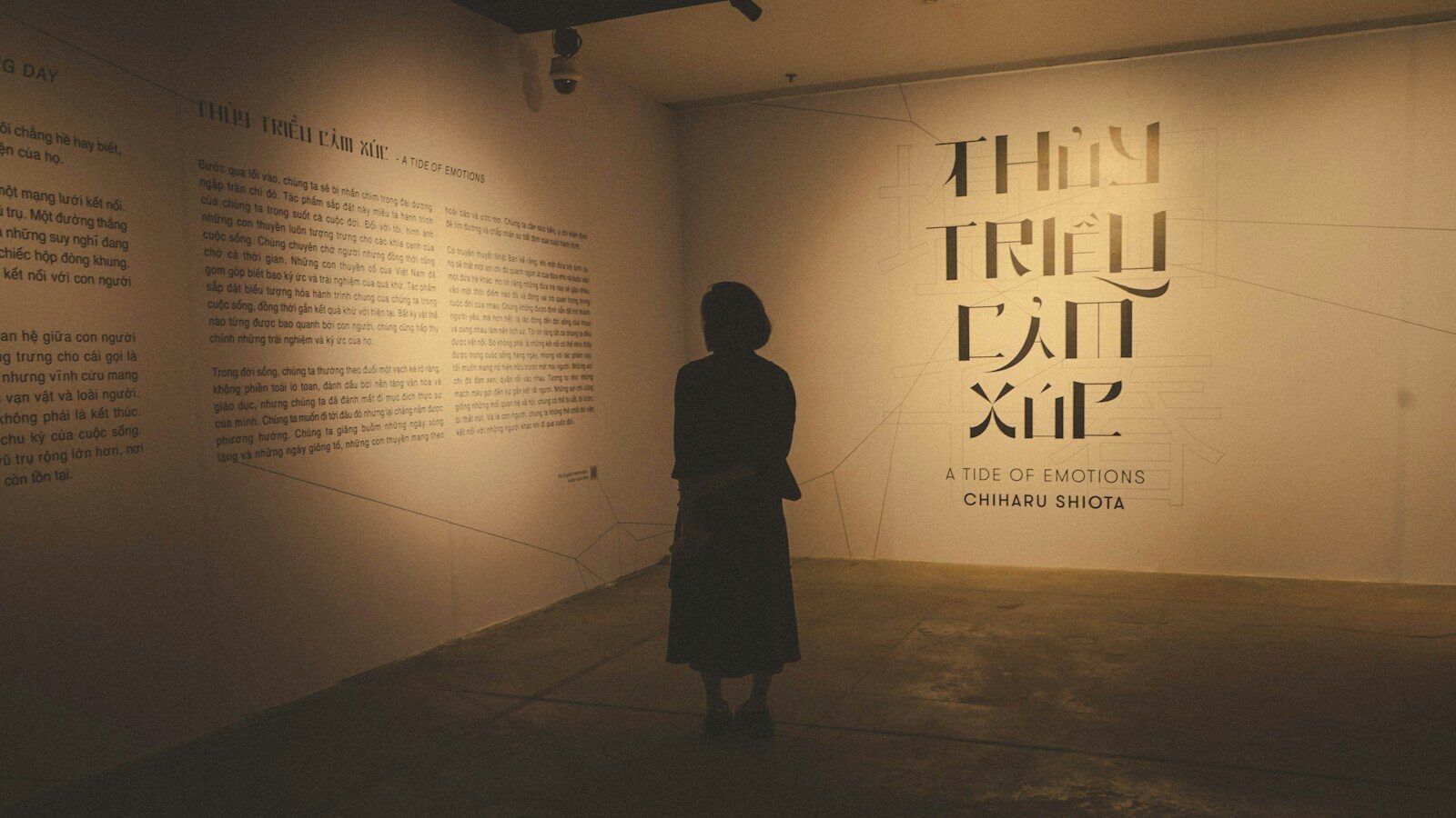 A person standing in a dimly lit room